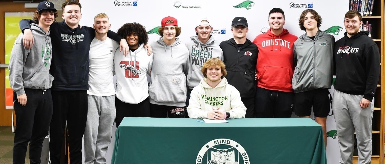 Student signing college document